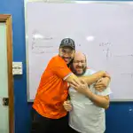 Joyful teachers celebrating academic success in a vibrant classroom setting.